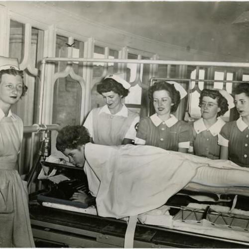 [Group of nurses with patient Benny Flippo at Children's Hospital]