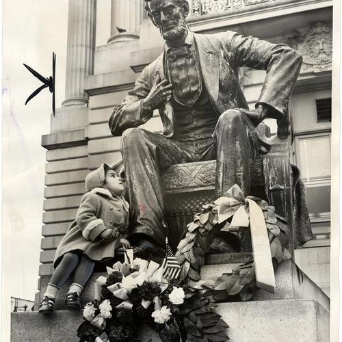 [Laura Hortencia Palmarez sits on Abraham Lincoln statue, City Hall, San Francisco, California]