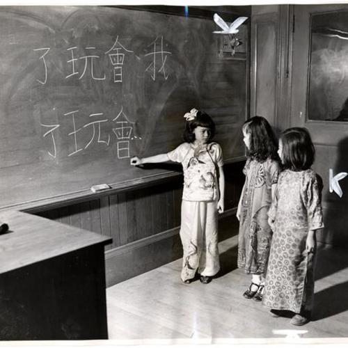 [Girls learning Chinese characters at Chinese Language School conducted by Paulist Fathers of Old St. Mary's at 902 Stockton street]
