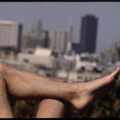 Person crossing legs sunbathing at Mission Dolores Park