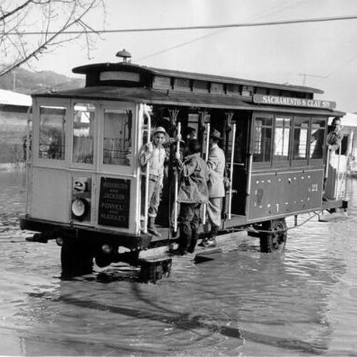[Motorized cable car acting as a taxi during flood]
