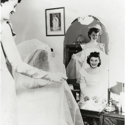 [Portrait of a bride and maid of honor in family home]