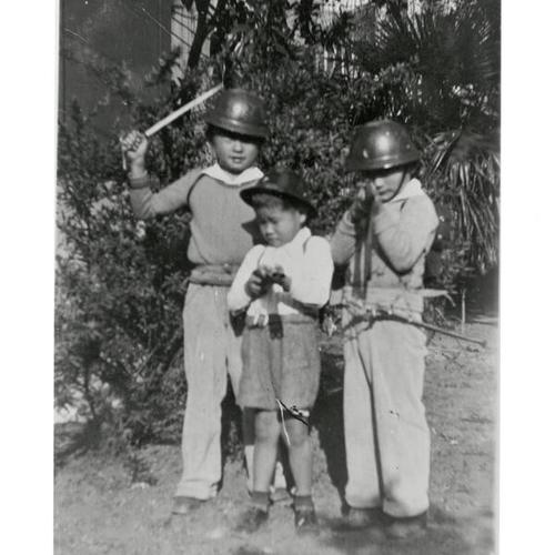 [Two brothers with friend playing soldiers]