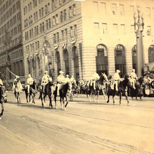 [Procession of riders on horses passing by spectators in the opening day celebration parade for San Francisco-Oakland Bay Bridge]