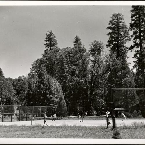 [Campers playing tennis at Camp Mather]
