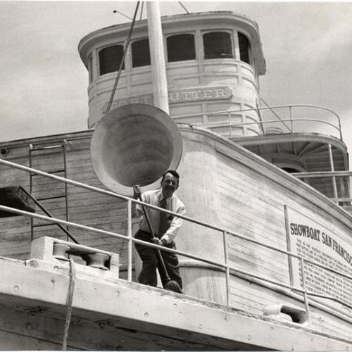 [Owner Barney Gould sweeping deck of his riverboat "Fort Sutter" at Aquatic Park]