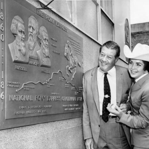 [Waddell F. Smith and De Anne Garibaldi standing next to a plaque commemorating the original Pony Express ride of 1860]