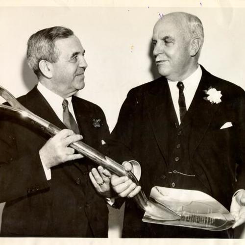 [William L. Hughson presents ceremonial golden spade to Governor James Rolph Jr. for Bay Bridge ground-breaking celebration]