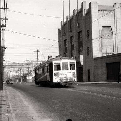 [16th Street and Bryant looking west at southbound #22 line car 864 passing Seals Stadium]