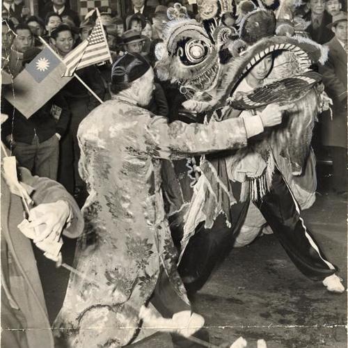 [Sze Sze, the Magnificent Lion, dancing through the streets of Chinatown during the Chinese New Year celebration]