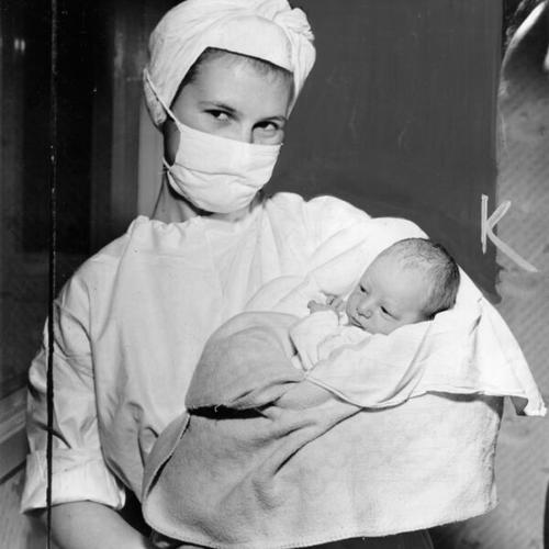[Nurse with newborn Harry Bridges Jr.]