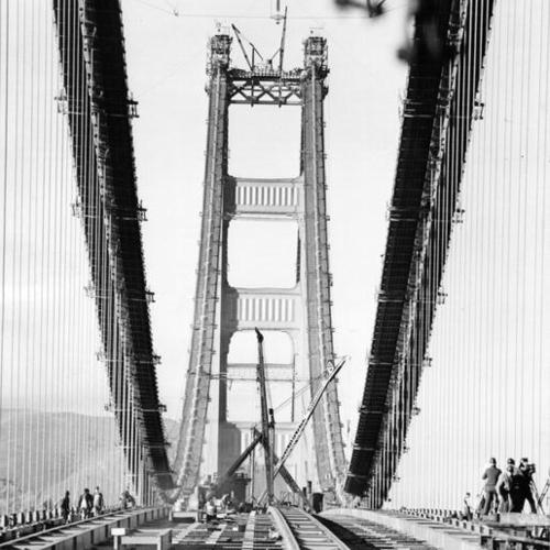 [Golden Gate Bridge deck being placed by workmen]