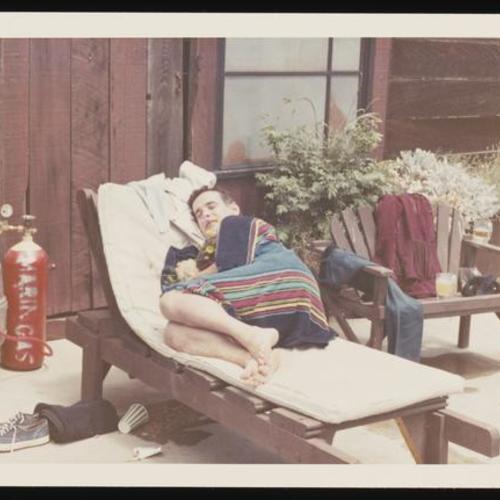 Person holding flowers sleeping poolside