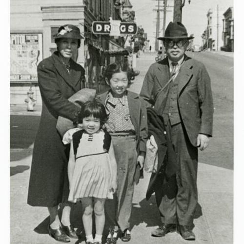 [Shige, Joanne, Mary and Ichiro standing on the corner of Post and Laguna Streets by Osawa Drug Store in 1938]