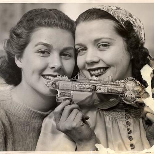 [Tanya Widrin and Zoe Dell Lantis presenting the golden jewel-studded key to open the Golden Gate International Exposition during the World Fair Premiere]