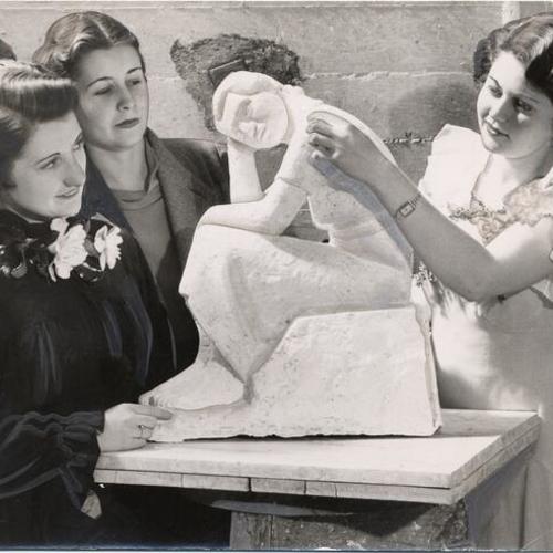 [Three women examining a sculpture at the California School of Fine Arts]