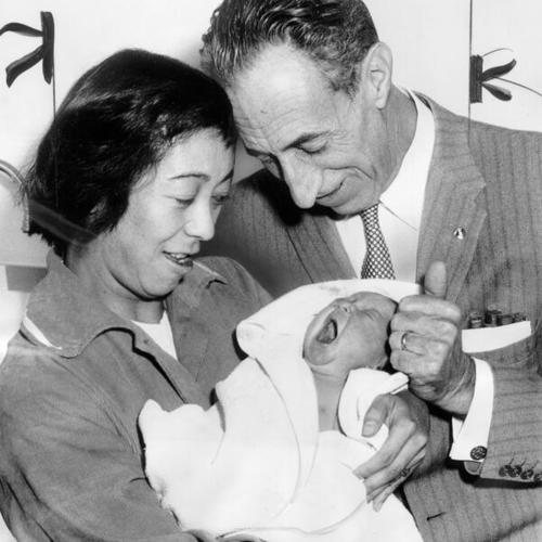 [Harry Bridges and his wife, Noriko, pose with their baby daughter]