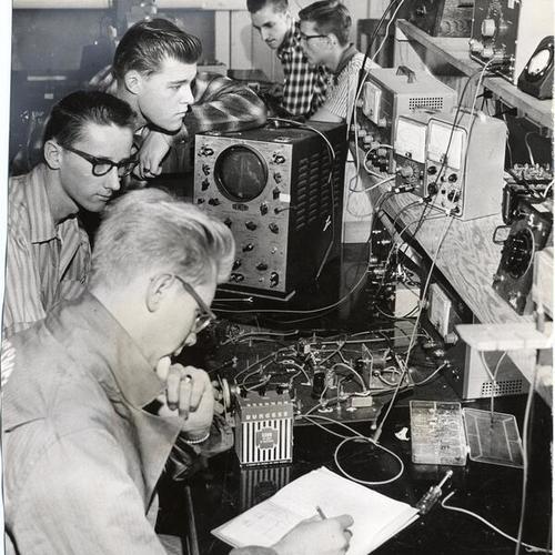 [Students working in an electronics laboratory at Cogswell Polytechnical College]