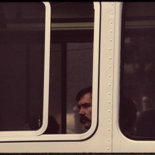 Person looking out bus window