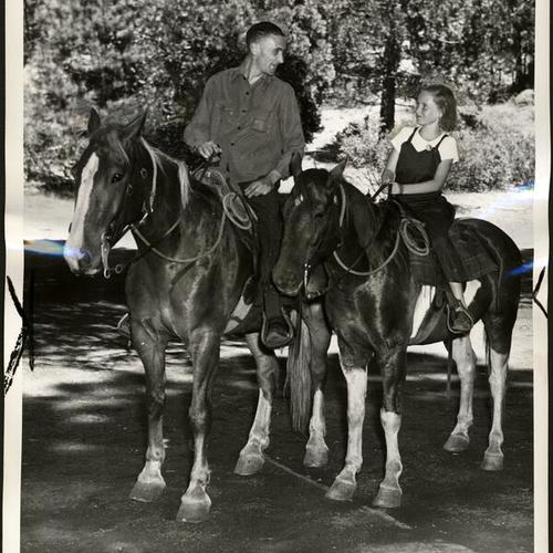 [Joe Barnes and vistor on horseback at Camp Mather]