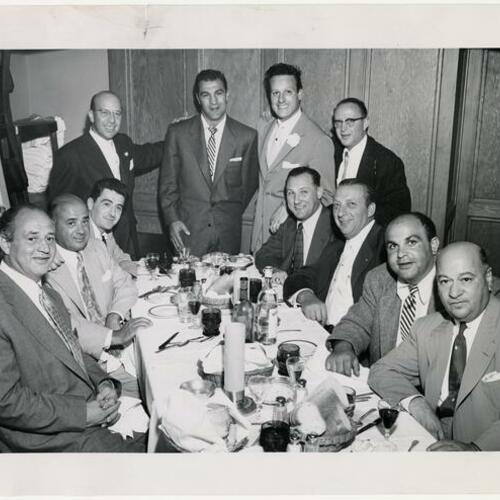 Judge John B. Molinari (sitting center, right) at dinner with others