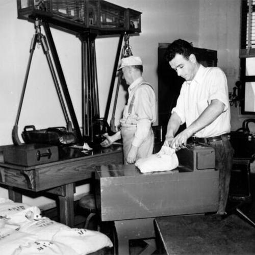 [Employees W. H. Deegan and Al Hamilton working at the U. S. Mint in San Francisco]