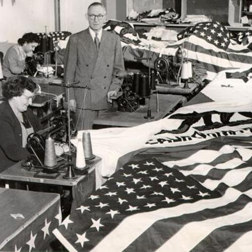 [Arthur Ganz of Argonaut Flag Corporation shown with seamstresses sewing flags]