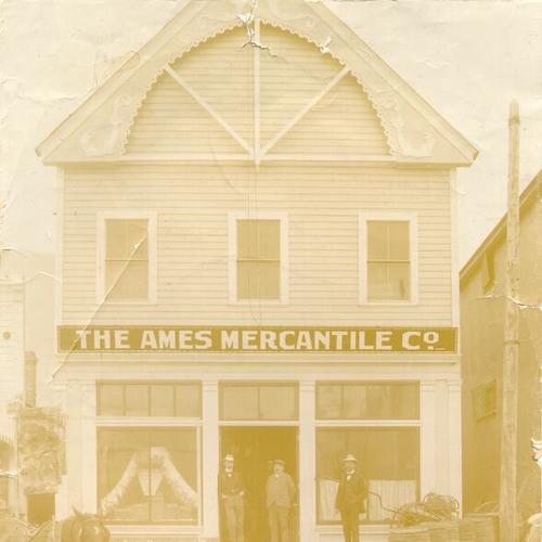 [Three men standing outside the Ames Mercantile Company]
