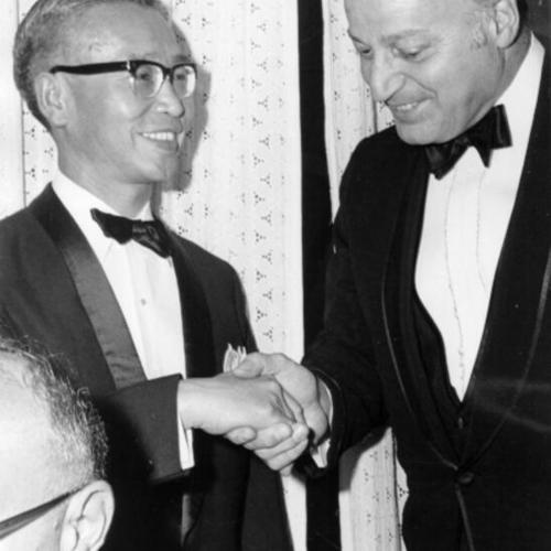 [Joseph Alioto shakes hands with the Consulate General of Japan at Centennial Dinner]