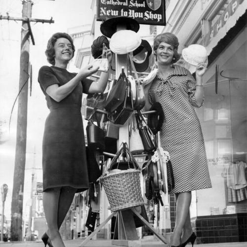 [Mrs. Paul Sack and Mrs. James Oliver displaying merchandise for sale at the New To You Shop at 1030 Hyde Street]