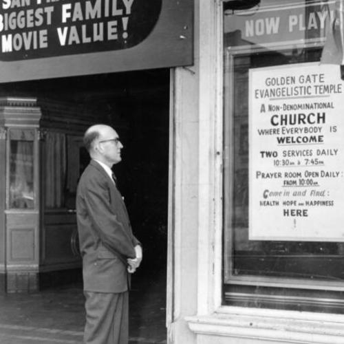 [Rev. Gaylord E. Atwell standing in front of the Golden Gate Evangelistic Temple]