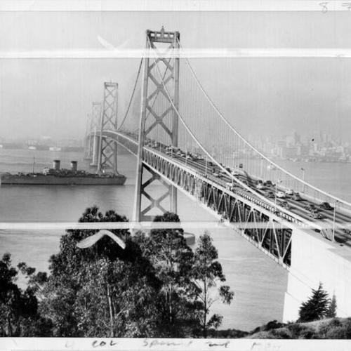 [Transport ship U.S.S. General George M. Randall passes beneath Bay Bridge upon return from Korea]