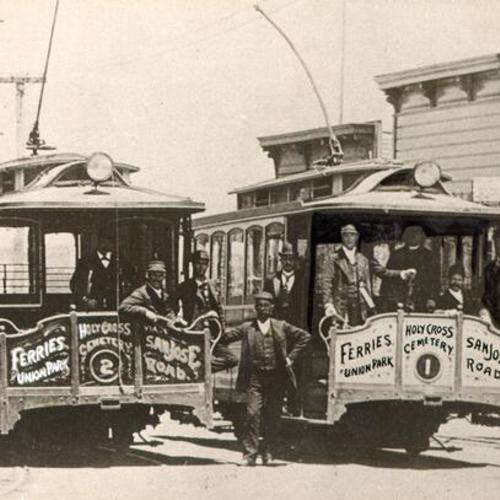 [Employees of the San Francisco & San Mateo Electric Railway Company posing with two streetcars]