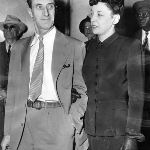 [Harry Bridges with his wife in the corridor of the San Francisco Federal Building]