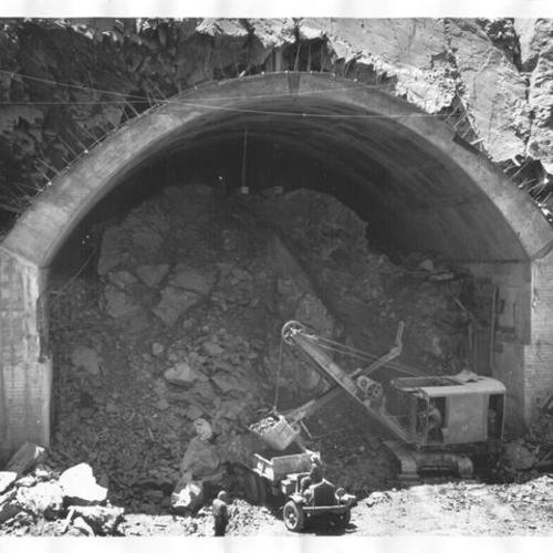 [View of steam shovel excavating for tunnel on Yerba Buena Island during San Francisco-Oakland Bay Bridge construction]