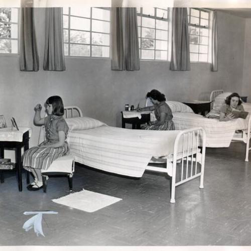 [Three girls in a residence hall at the Convent of the Good Shepherd]
