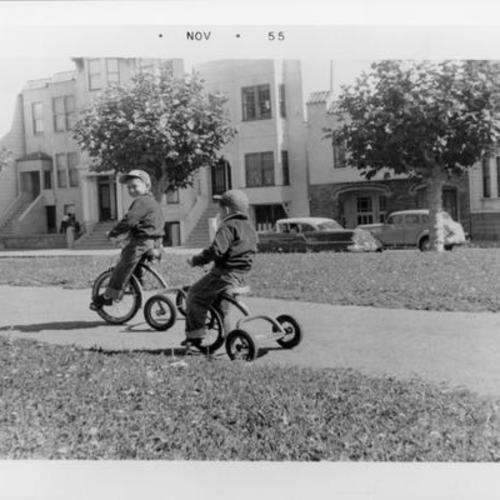 [Two boys riding tricycles in Garfield Park]