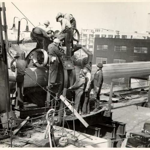 [Men working on cables during construction of the San Francisco-Oakland Bay Bridge]