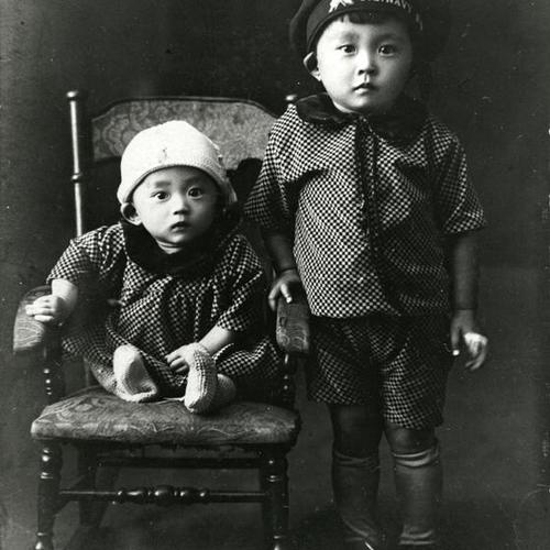 [Siblings in matching outfits posing for photo in 1927]