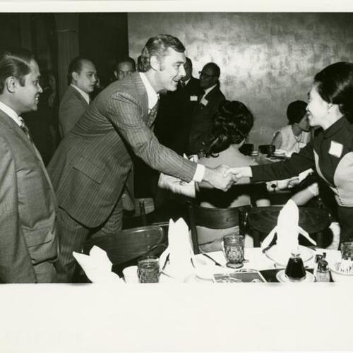 [George Moscone meeting Mrs. Mario Borja and Dr. Cesar Ortiz on the left]