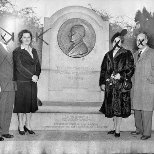 [Marchesa Guglielmo Marconi, Baroness Marion Muzi-Falconi, the Baron and an unidentified man visiting the memorial to Guglielmo Marconi]