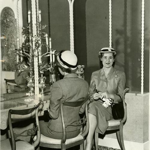 [Two women in the women's lounge at The Emporium's Stonestown store]