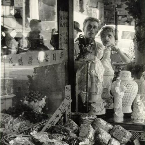 [Shoppers looking into a store window on Grant Avenue in Chinatown]