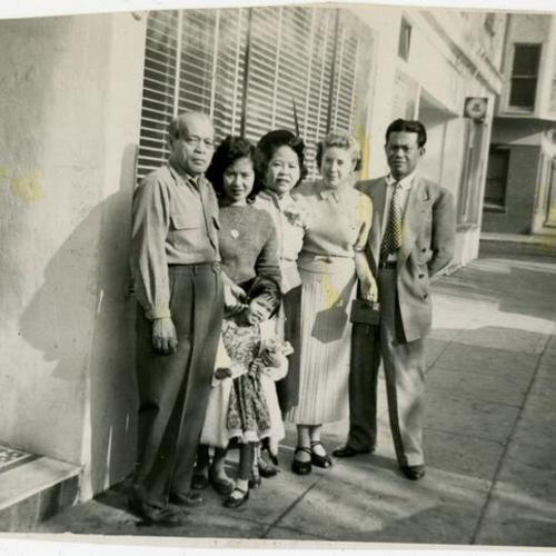 [Melecio, Raquel, Joan May T., Tranquilina, Val and Braulio in front of the Gran Oriente Filipino Apartment Hotel]