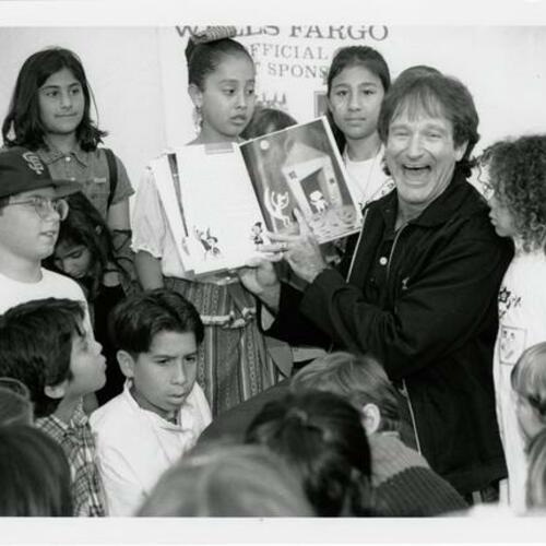 [Robin Williams reads to a group of children on opening day of the new Main branch of the San Francisco Public Library]