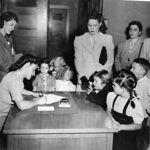 [Children registering for school at John Muir School]