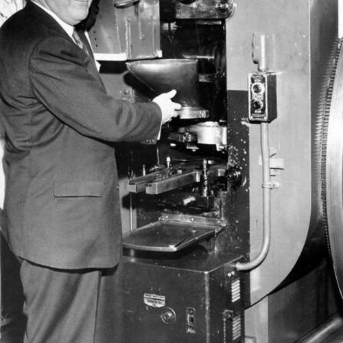 [Superintendent Arthur Carmichael inspecting a 77 year-old coin press at the U. S. Mint in San Francisco]