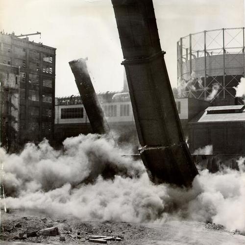 [Demolition of two brick smokestacks at the Spreckels Sugar Refinery]