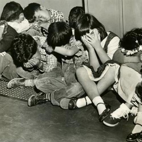 [Children at Francisco School participate in a "take cover" drill as part of Operation Alert, a 6-day nationwide atomic attack drill]