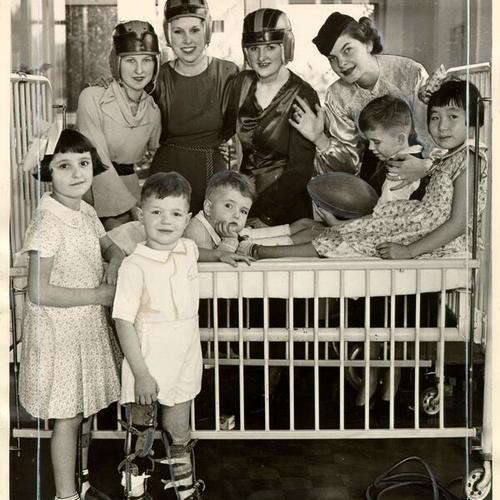 [KYA radio station personalities visiting patients at the Shriners' Hospital for Crippled Children]